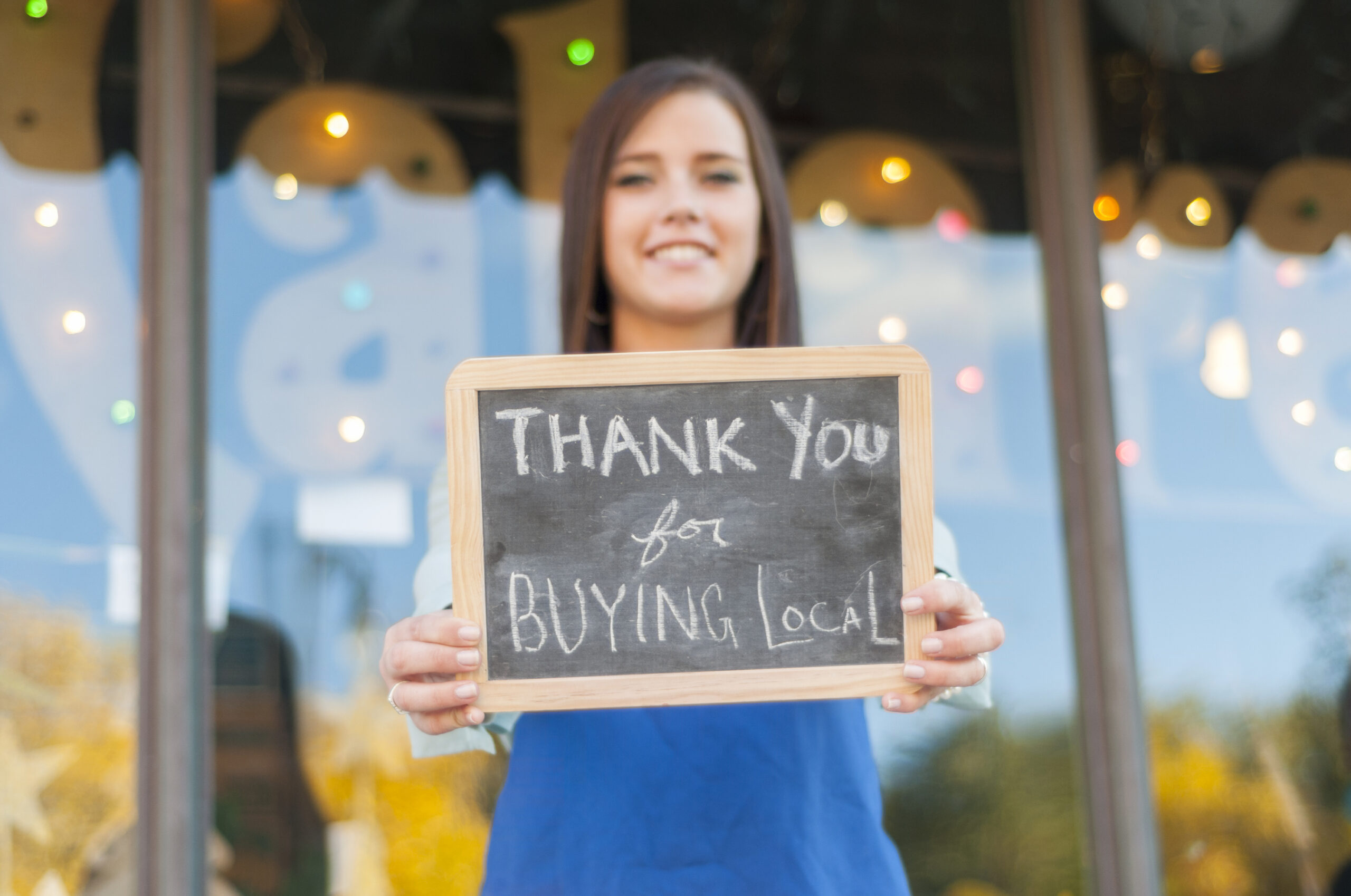 Young girl with chalkboard sign